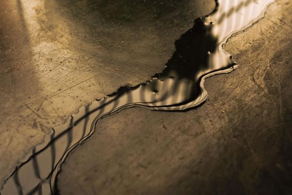Closeup of a water puddle on a concrete floor